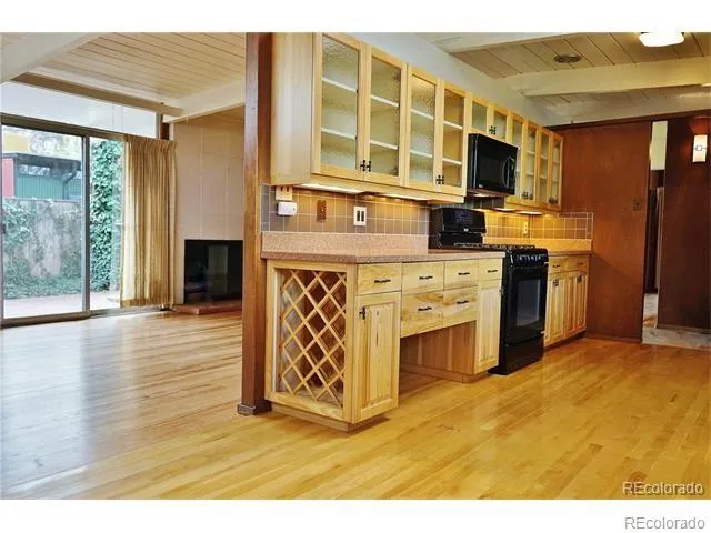 a kitchen with stainless steel appliances granite countertop a stove top oven a sink dishwasher a refrigerator and a microwave