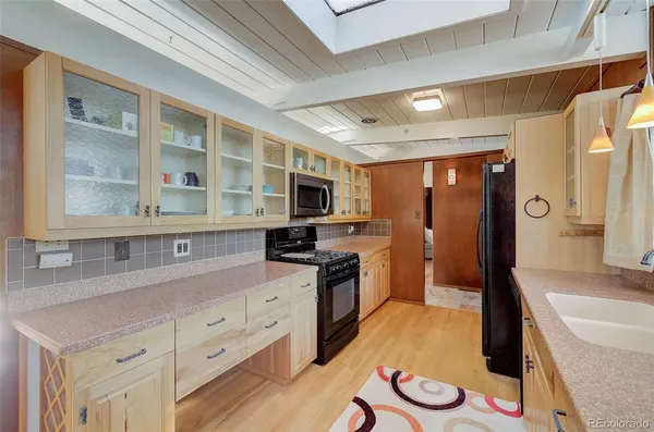 a kitchen with stainless steel appliances granite countertop a sink and cabinets