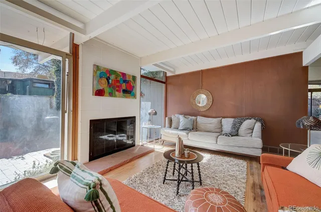 a living room with furniture and a fireplace