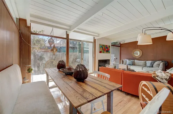 a living room with furniture a rug and a large window