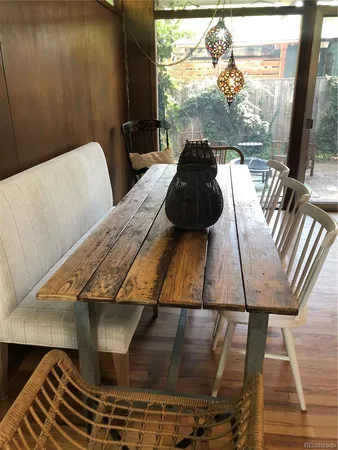 a outdoor dining space with furniture and wooden floor