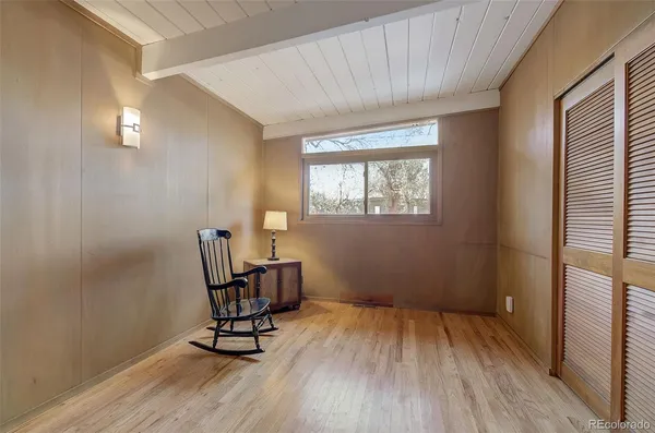 a view of empty room with window and wooden floor