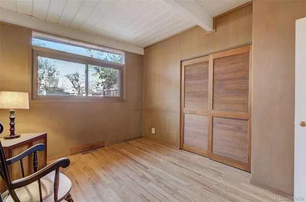 a view of a room with wooden floor and door