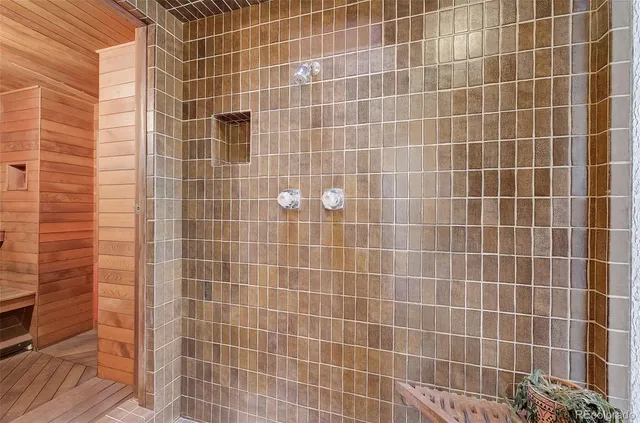 a bathroom with a bathtub shower sink mirror and toilet