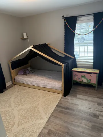 a bedroom with a bed and a window