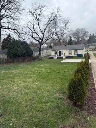 a swimming pool with outdoor seating and yard