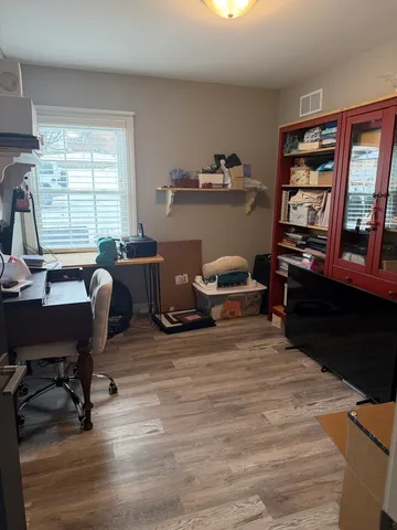 a view of a workspace with furniture and a window