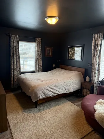 a bedroom with a bed and a lamp with window