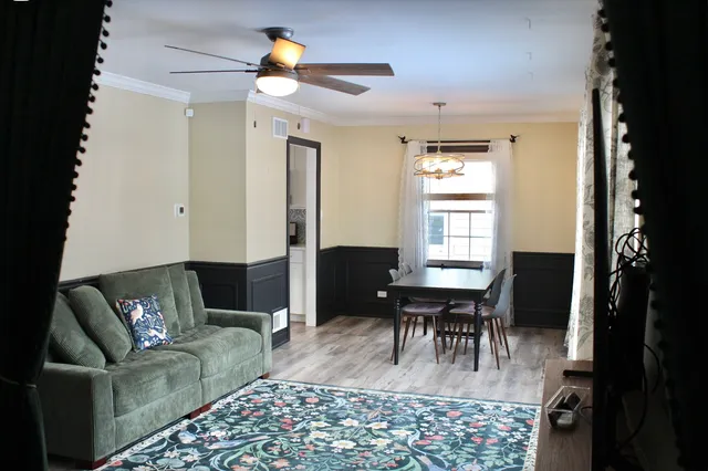 a living room with furniture a dining table and a piano door