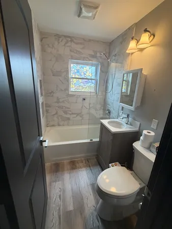 a bathroom with a toilet a sink and bathtub