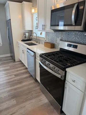a kitchen with granite countertop a stove and a sink