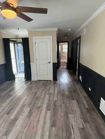 a view of empty room with wooden floor