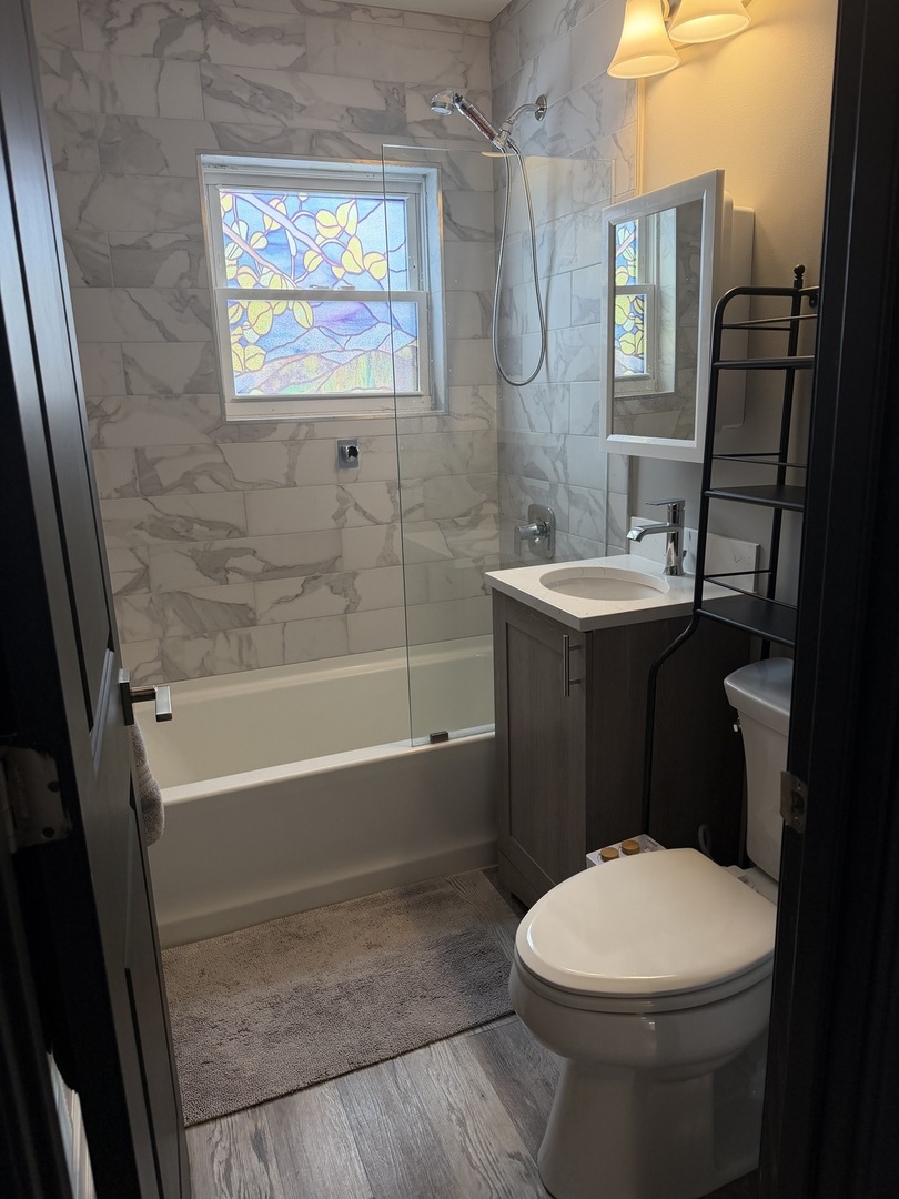 301 Sheldon Avenue Downers Grove, IL 60515 - Photo 10 of 16 a bathroom with a sink a toilet and shower