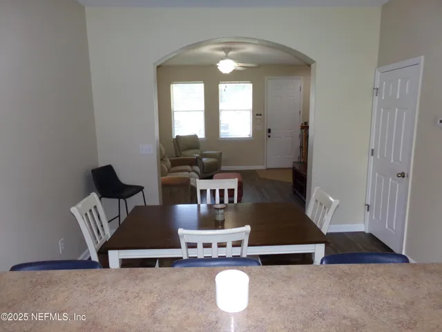 front view of a brick house with a yard