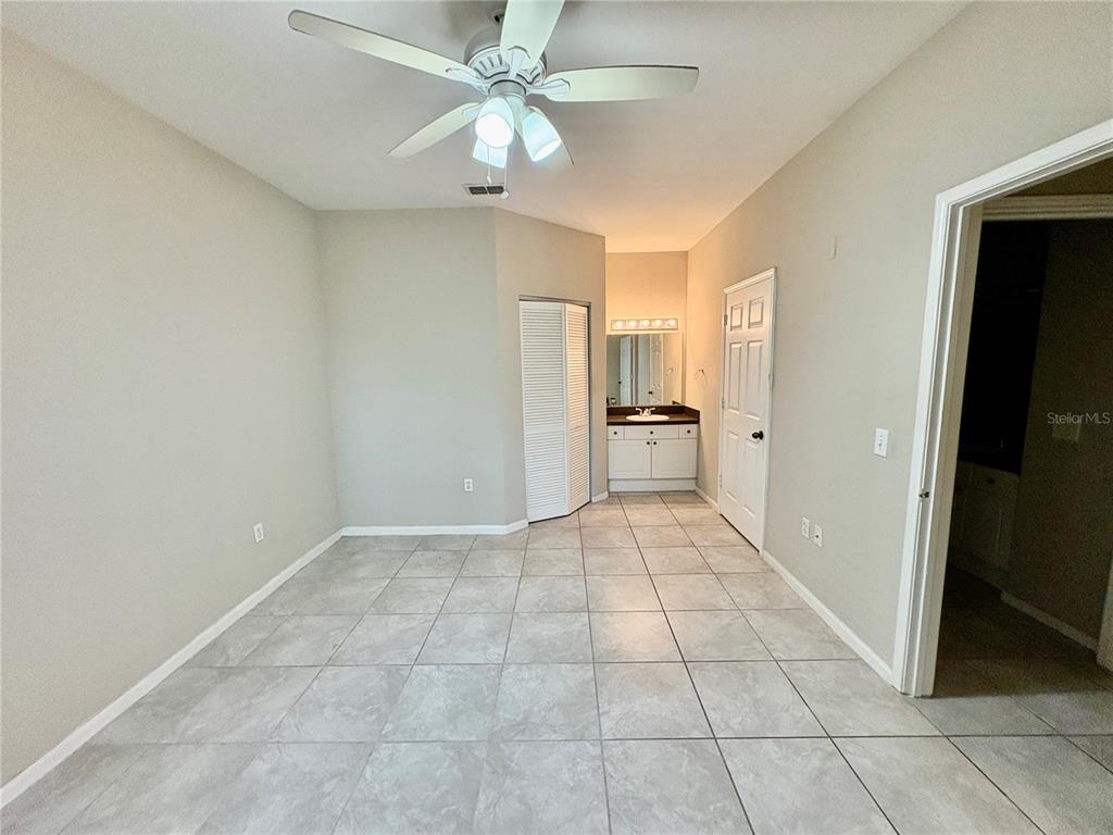 2199 Chianti Place, Unit 918 Palm Harbor, FL 34683 - Photo 7 of 23 wooden floor in an empty room and a bathroom
