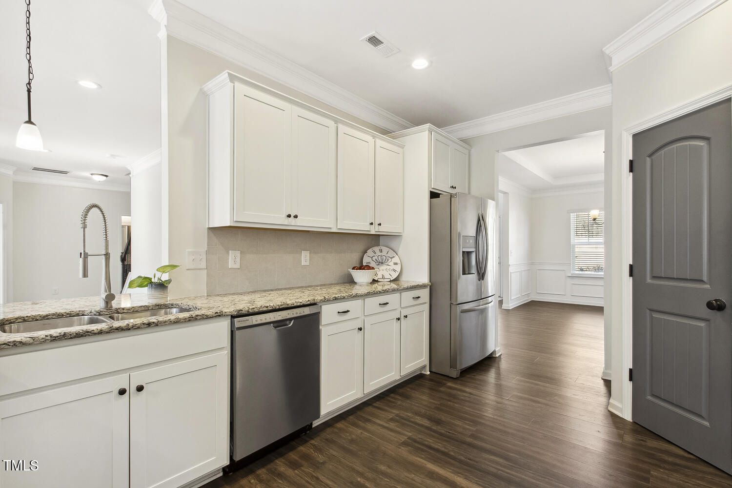 192 Springhill Lane Garner, NC 27529 - Photo 13 of 43 a kitchen with a sink cabinets stainless steel appliances and wooden floor