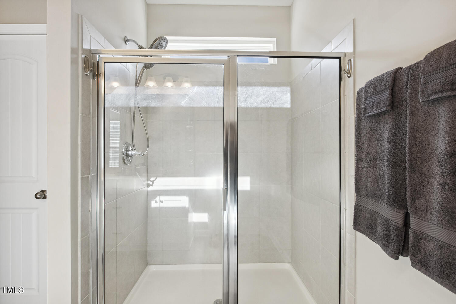 192 Springhill Lane Garner, NC 27529 - Photo 29 of 43 a bathroom with a glass shower door