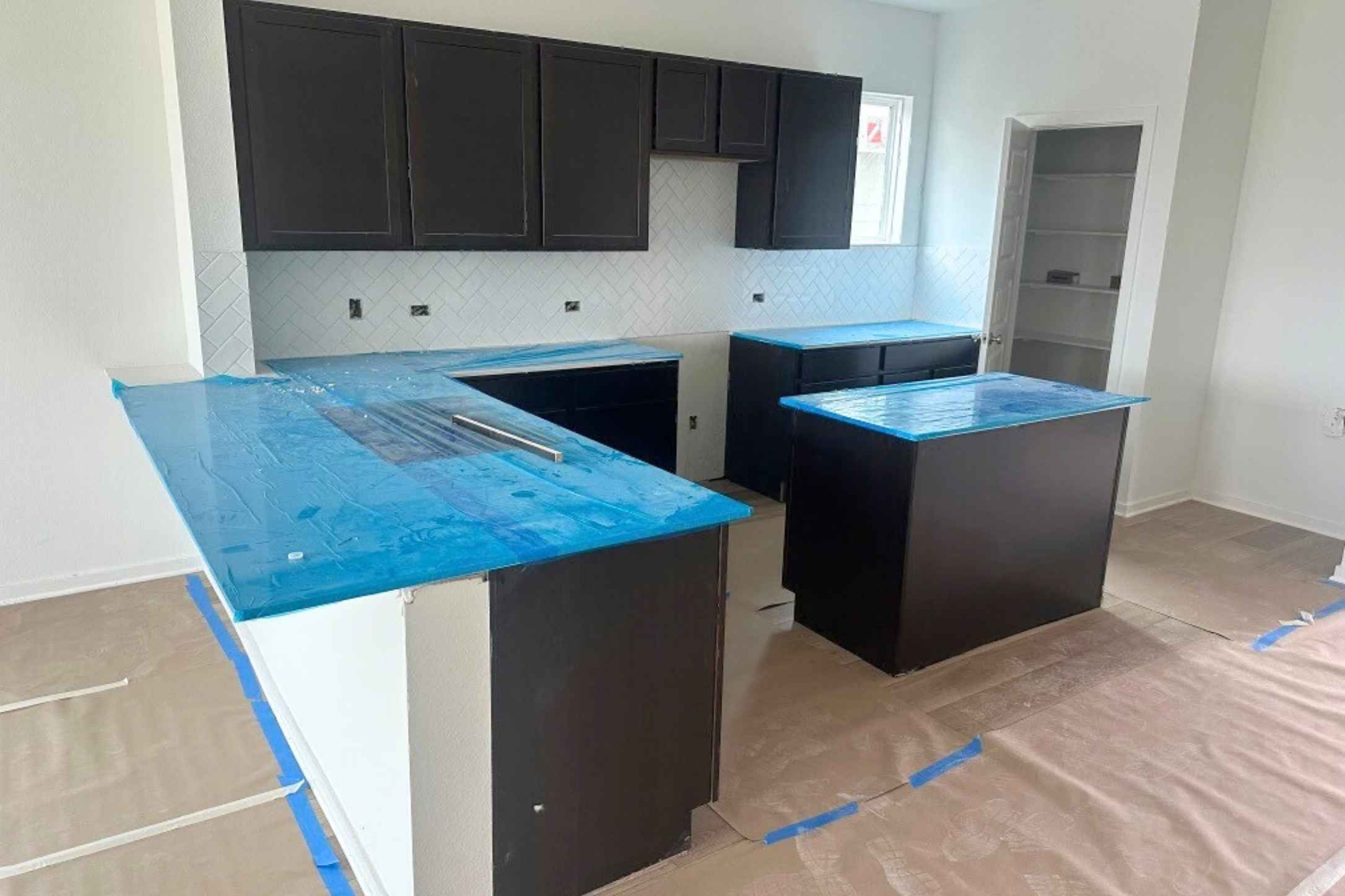 13725 Tucker Hedge Pass Elgin, TX 78621 - Photo 2 of 30 Kitchen featuring dark cabinets, tasteful backsplash, and a peninsula