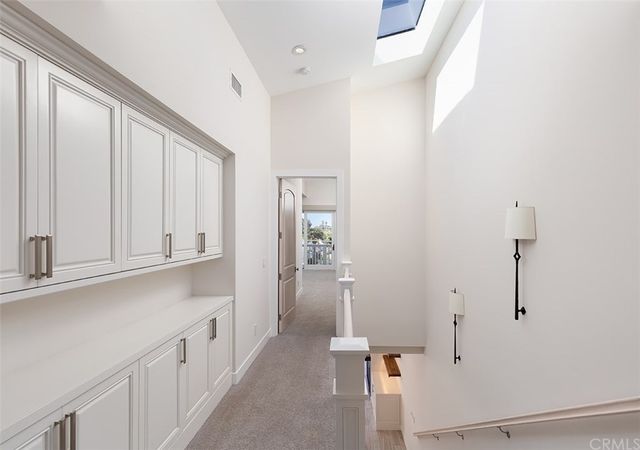 a view of a kitchen with white cabinets