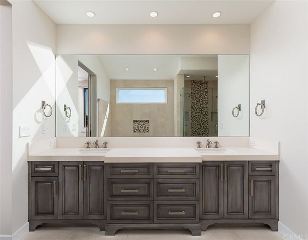 a bathroom with a double vanity sink and a mirror
