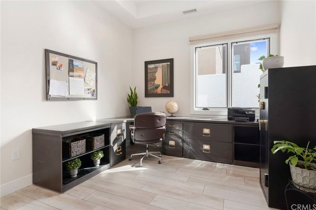 a livingroom with workspace and a window