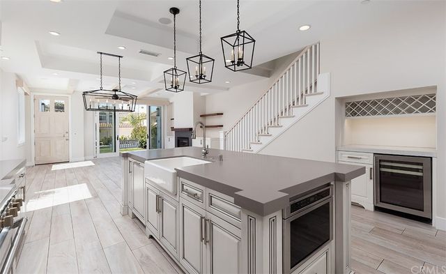 a kitchen with a stove and a chandelier