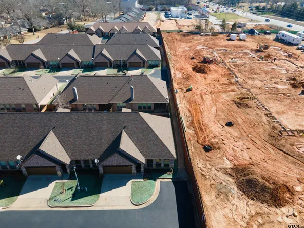 an aerial view of multiple houses with yard