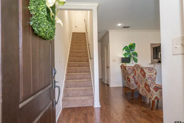 a view of a livingroom with furniture and stairs