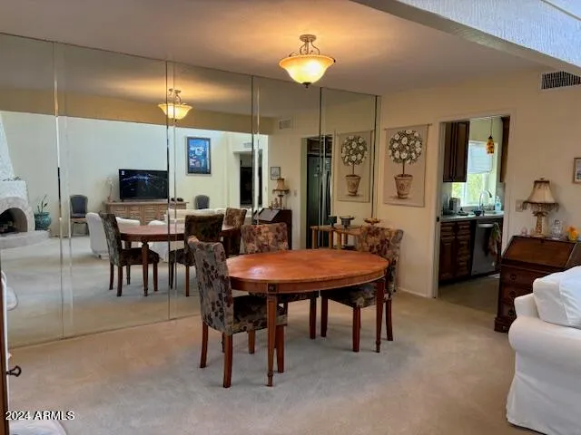 a view of a a dining room with furniture window and wooden floor