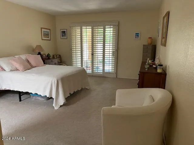 a bedroom with a bed and a couch