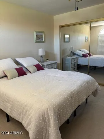 a bedroom with a bed and a mirror