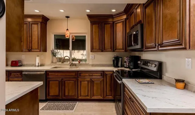 a kitchen with a sink stove and cabinets
