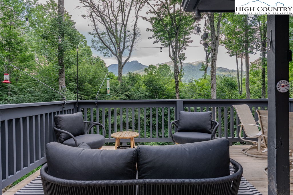 102 Ridge Drive Linville, NC 28646 - Photo 47 of 48 a balcony with couches and a potted plant on a table