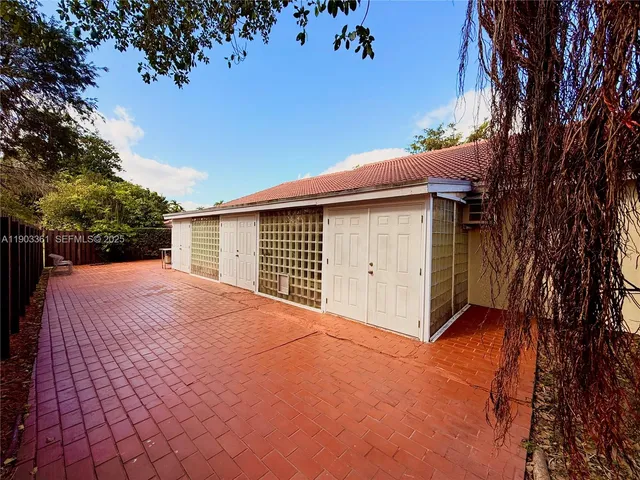 a backyard of a house with a yard and garage