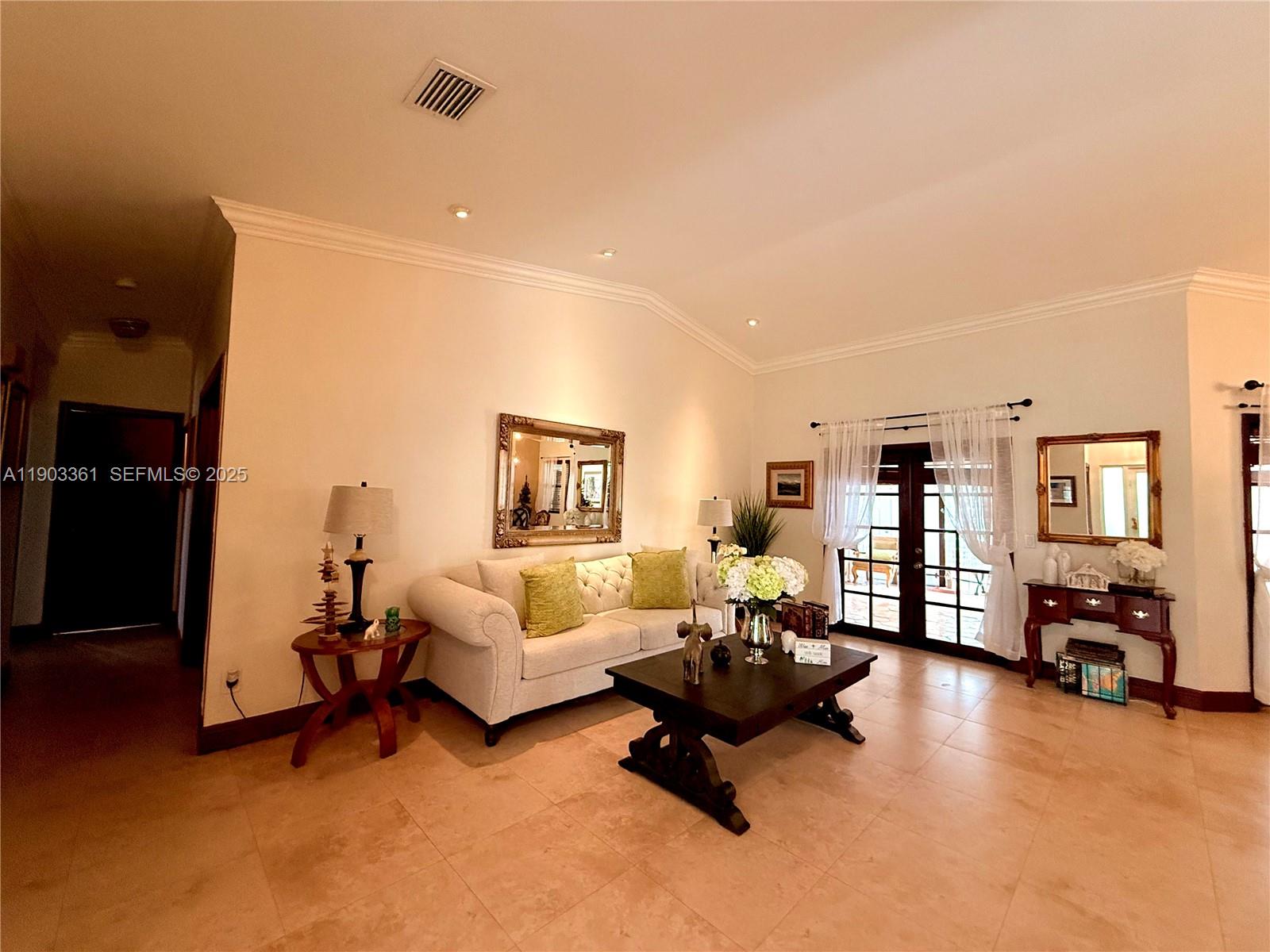 14970 Southwest 46th Terrace Miami, FL 33185 - Photo 2 of 27 a living room with furniture and a flat screen tv
