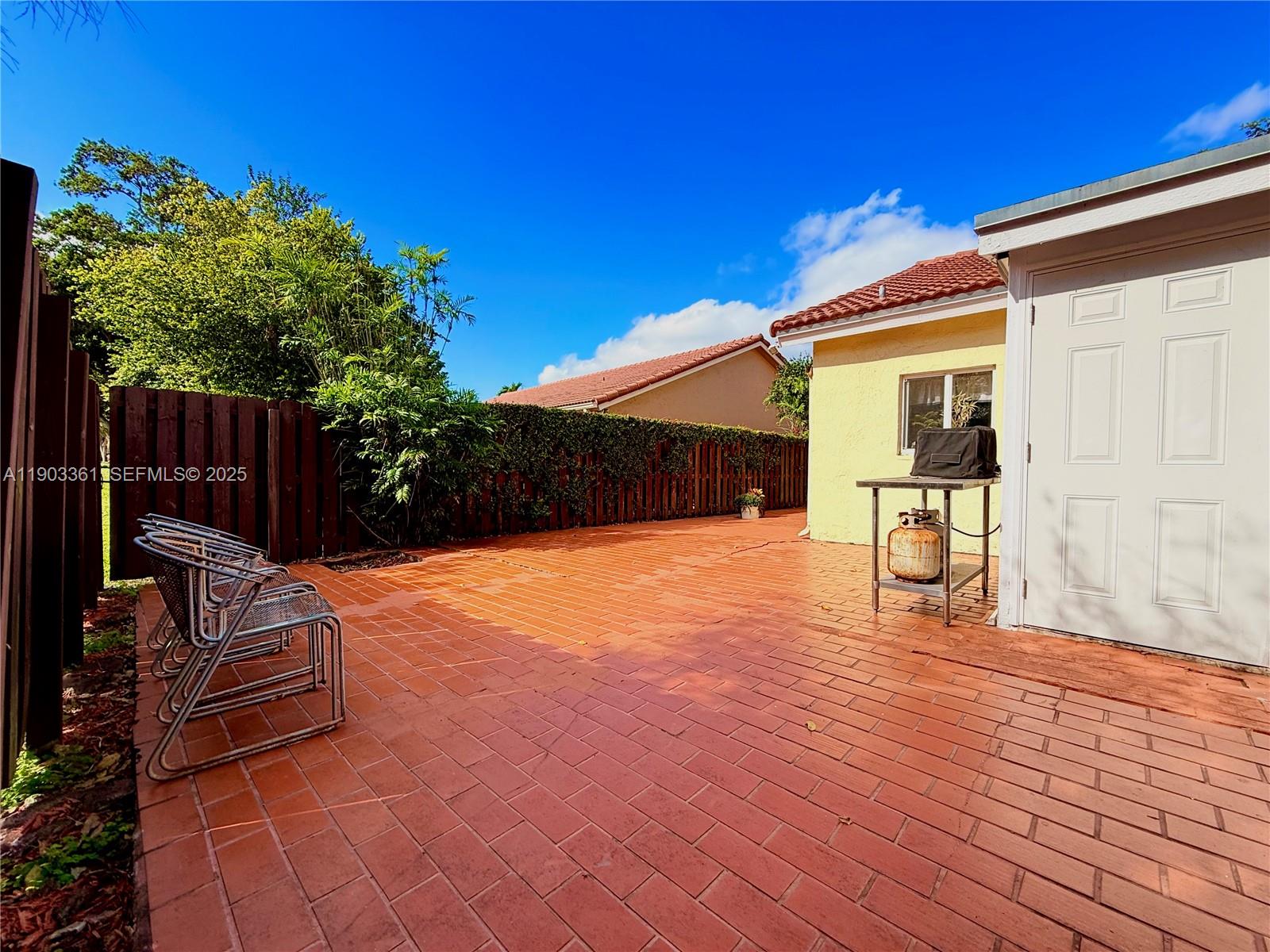14970 Southwest 46th Terrace Miami, FL 33185 - Photo 21 of 27 a backyard of a house with seating space