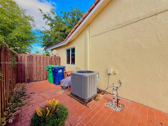 a view of a backyard with table and chairs and wooden fence