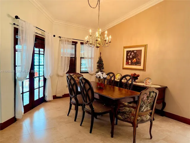 a view of a a dining room with furniture window and wooden floor