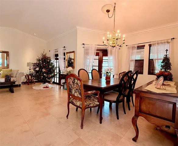 a view of a dining room with furniture and chandelier