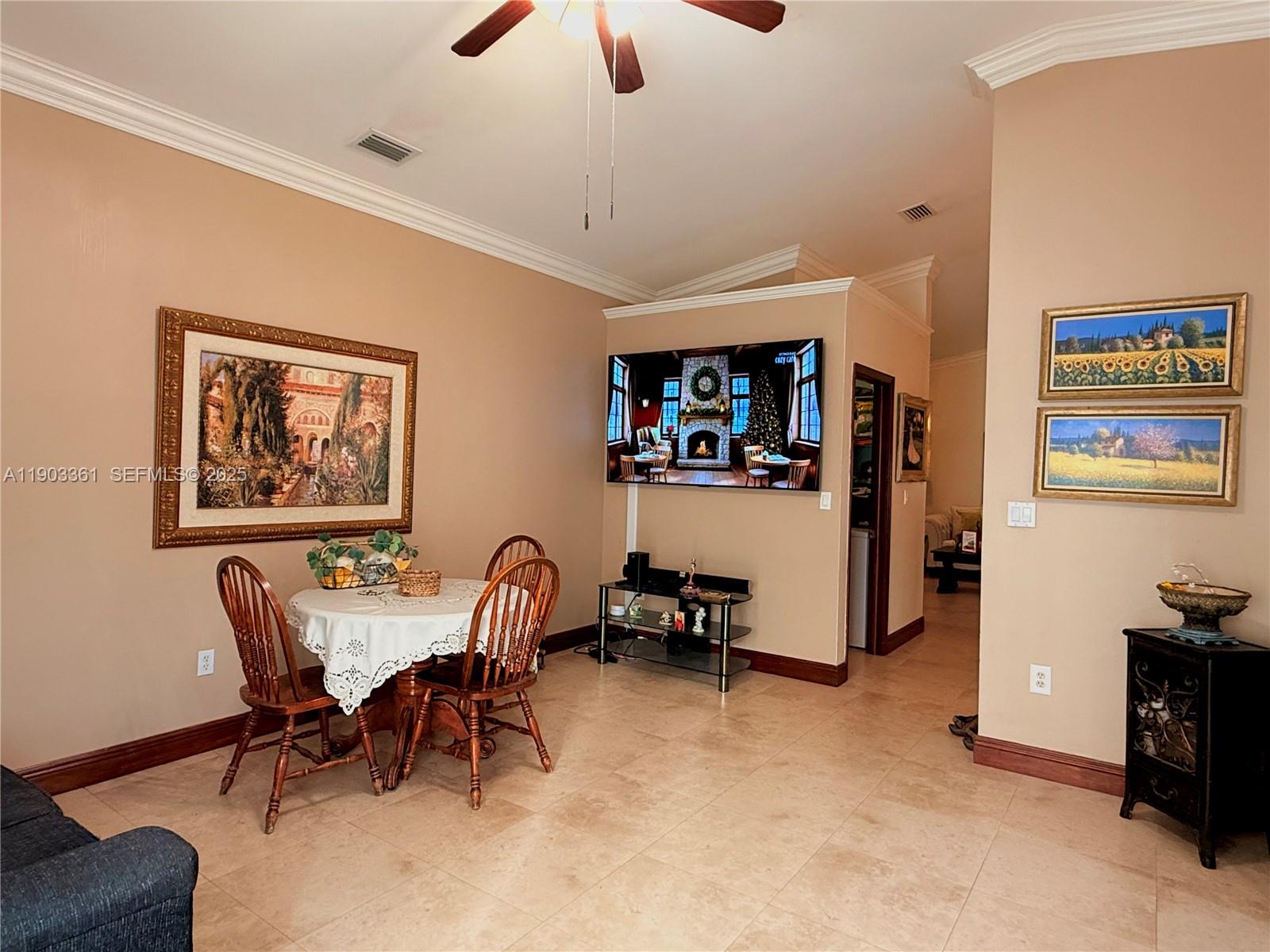 14970 Southwest 46th Terrace Miami, FL 33185 - Photo 7 of 27 a view of a livingroom and a dining room with furniture and a chandelier