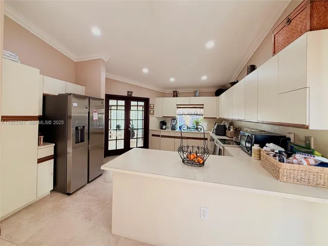 a kitchen with stainless steel appliances a refrigerator and a sink