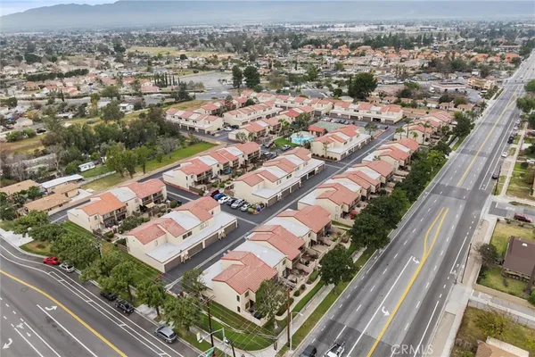 an aerial view of residential houses with yard