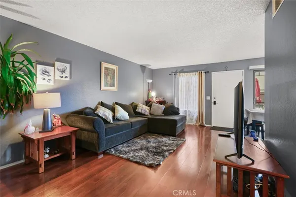 a living room with furniture rug and wooden floor