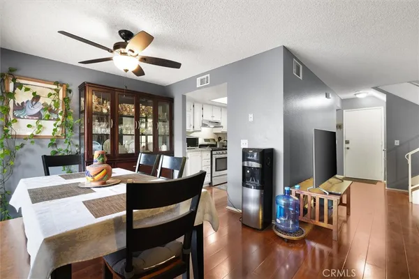 a dining room with furniture a window and wooden floor