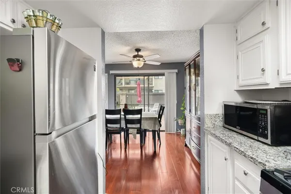 a view of a kitchen with microwave and furniture