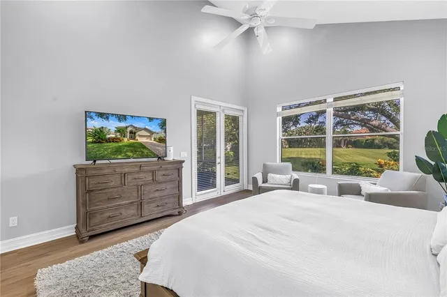a bedroom with a bed couch and chandelier
