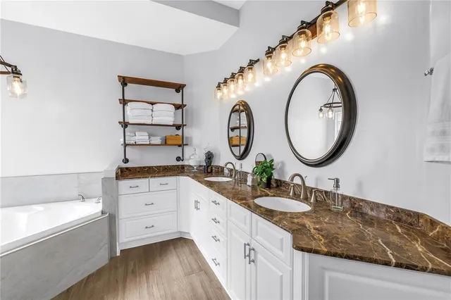 a view of a hallway with wooden floor windows and a kitchen