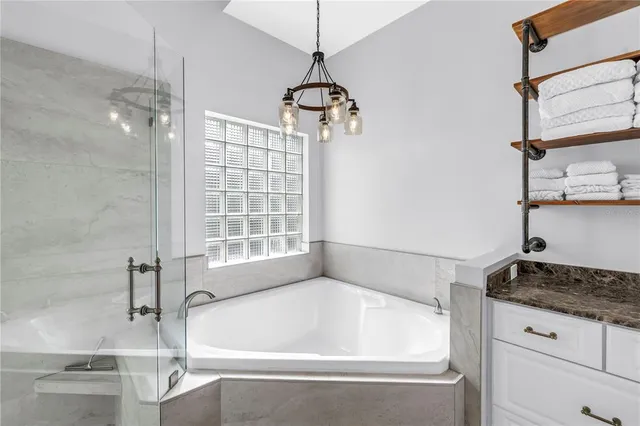 a bathroom with a granite countertop sink toilet and a mirror