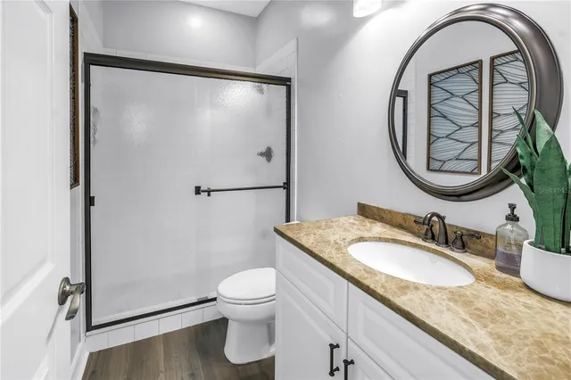 a view of a green field with wooden fence