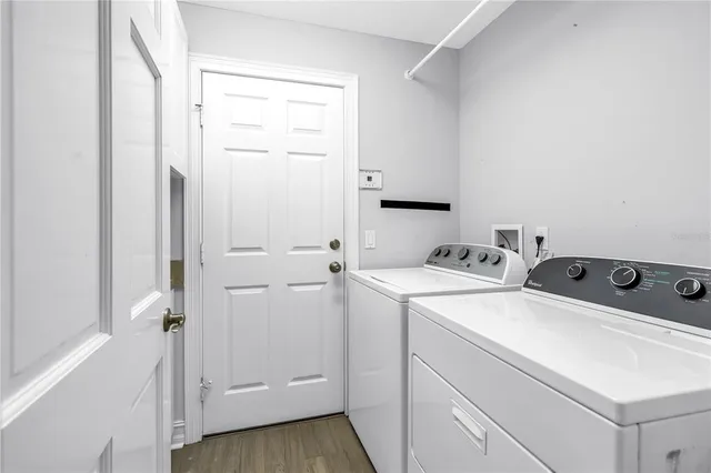 a view of a swimming pool with lawn chairs and a fire pit